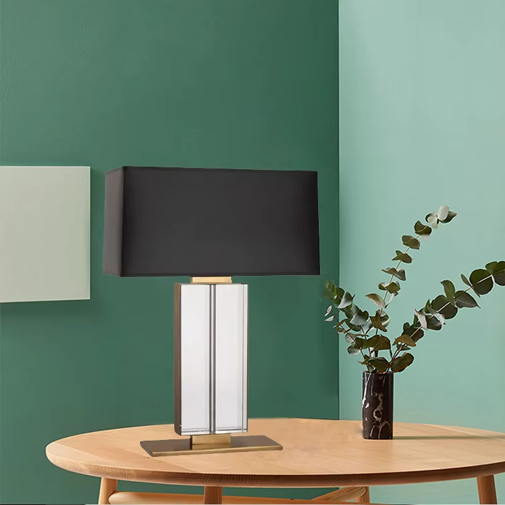 This is a modern light luxury crystal column table lamp, with a black rectangular fabric lampshade paired with a transparent cut crystal column base, accented with gold metal details, featuring both decorative and lighting functions, ideal for high-end indoor scenarios such as living room side tables and bedroom nightstands.