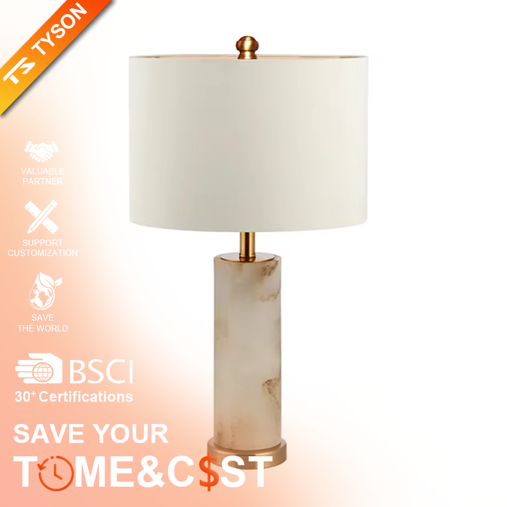This is a light luxury minimalist table lamp, featuring a natural marble lamp post paired with gold metal accents and an off-white fabric lampshade. It emits soft and gentle light, serving both lighting and decorative purposes, suitable for bedroom nightstands, hotel guest rooms, light luxury living room side tables, showrooms and other scenarios.