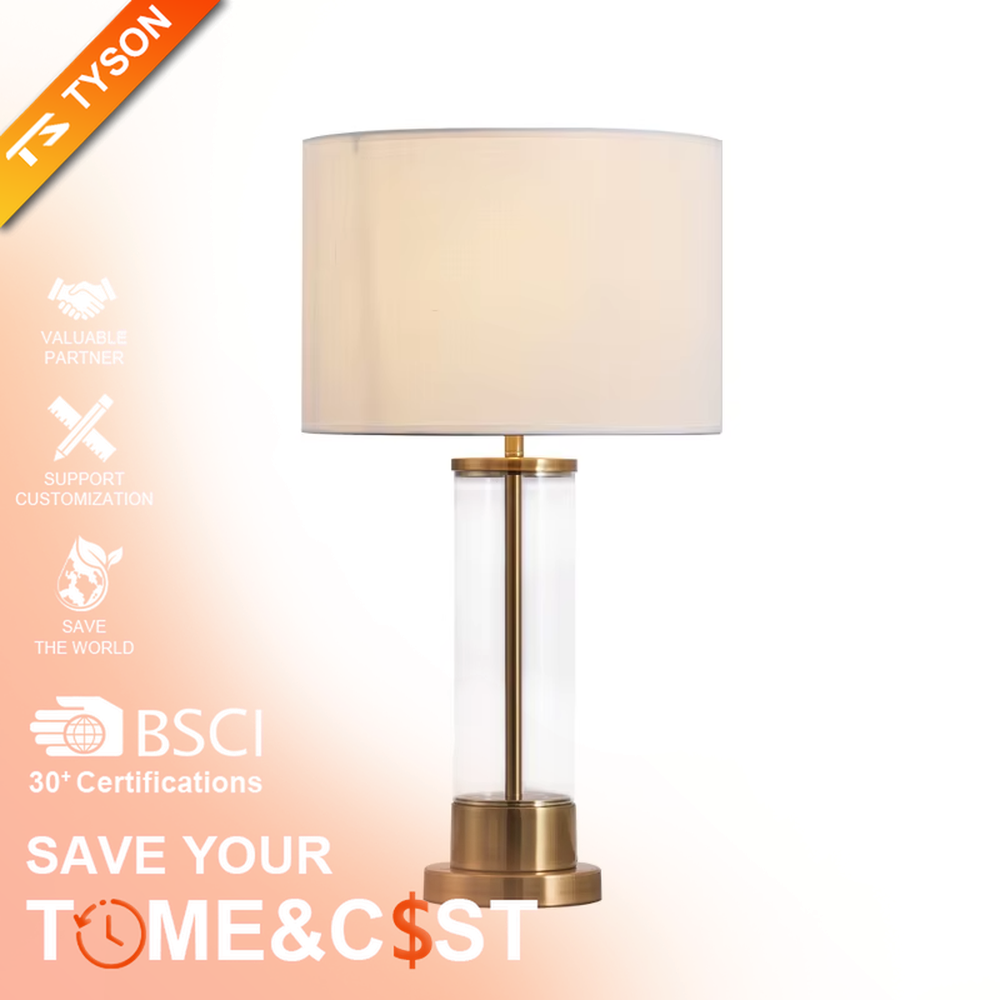 This modern light luxury table lamp features a transparent glass lamp body, paired with gold metal connectors and base, and an off-white fabric cylindrical lampshade that transmits light softly. It serves both lighting and decorative purposes, ideal for light luxury spaces such as bedroom bedside tables, living room side tables, and hotel guest rooms.