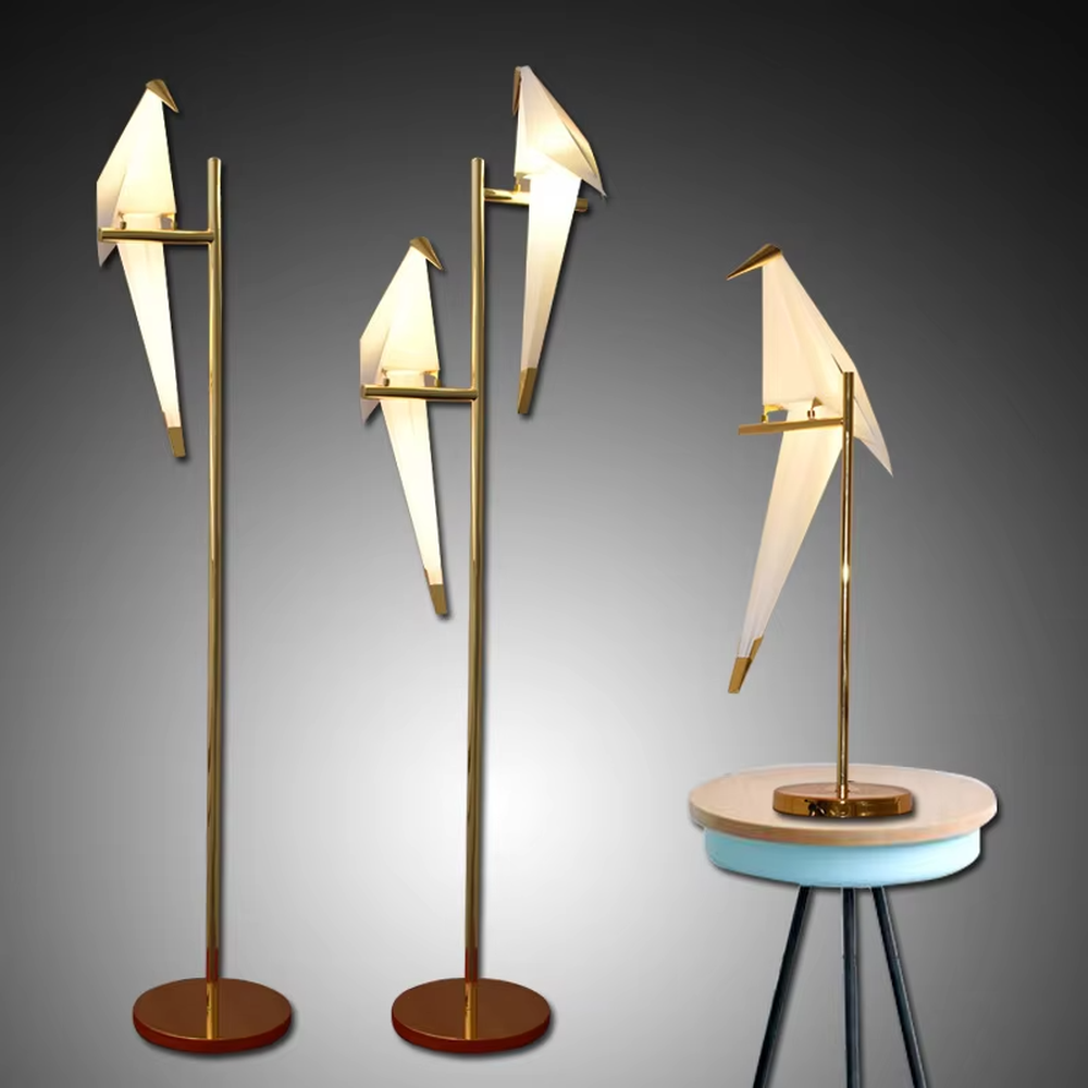 This is a modern light luxury origami crane-shaped floor lamp, featuring a gold metal stand paired with a translucent paper art lamp body. The lamp body is as dynamic and soft as an origami crane, serving both lighting and artistic decoration purposes, suitable for bedrooms, light luxury living rooms, hotel guest rooms, showrooms and other scenarios.