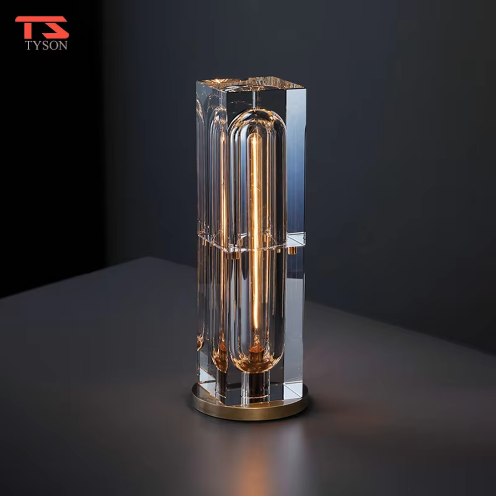 Modern light luxury cut crystal column table lamp, with a transparent multi-faceted cut crystal lamp body paired with a gold metal base, emitting soft and transparent light, combining decorativeness and practicality, suitable for lighting and decoration in spaces such as bedroom nightstands, living room side tables, and hotel guest rooms.