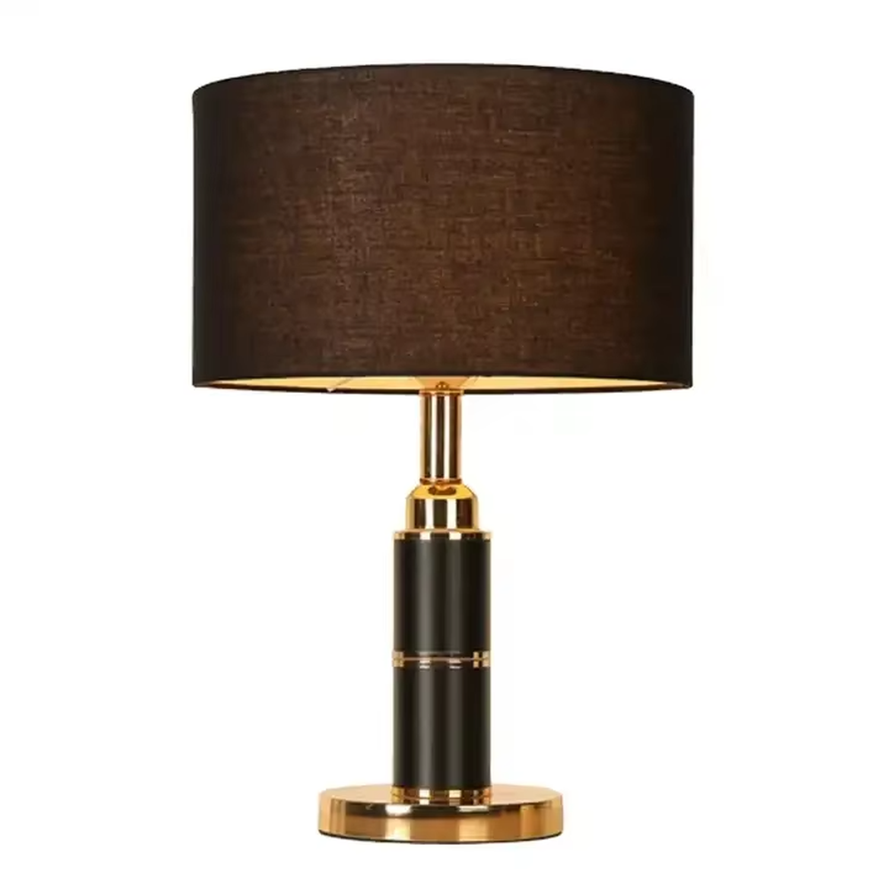 Light luxury brown fabric shade black-gold cylindrical base table lamp, warm light effect, creating a calm and high-end space atmosphere.
