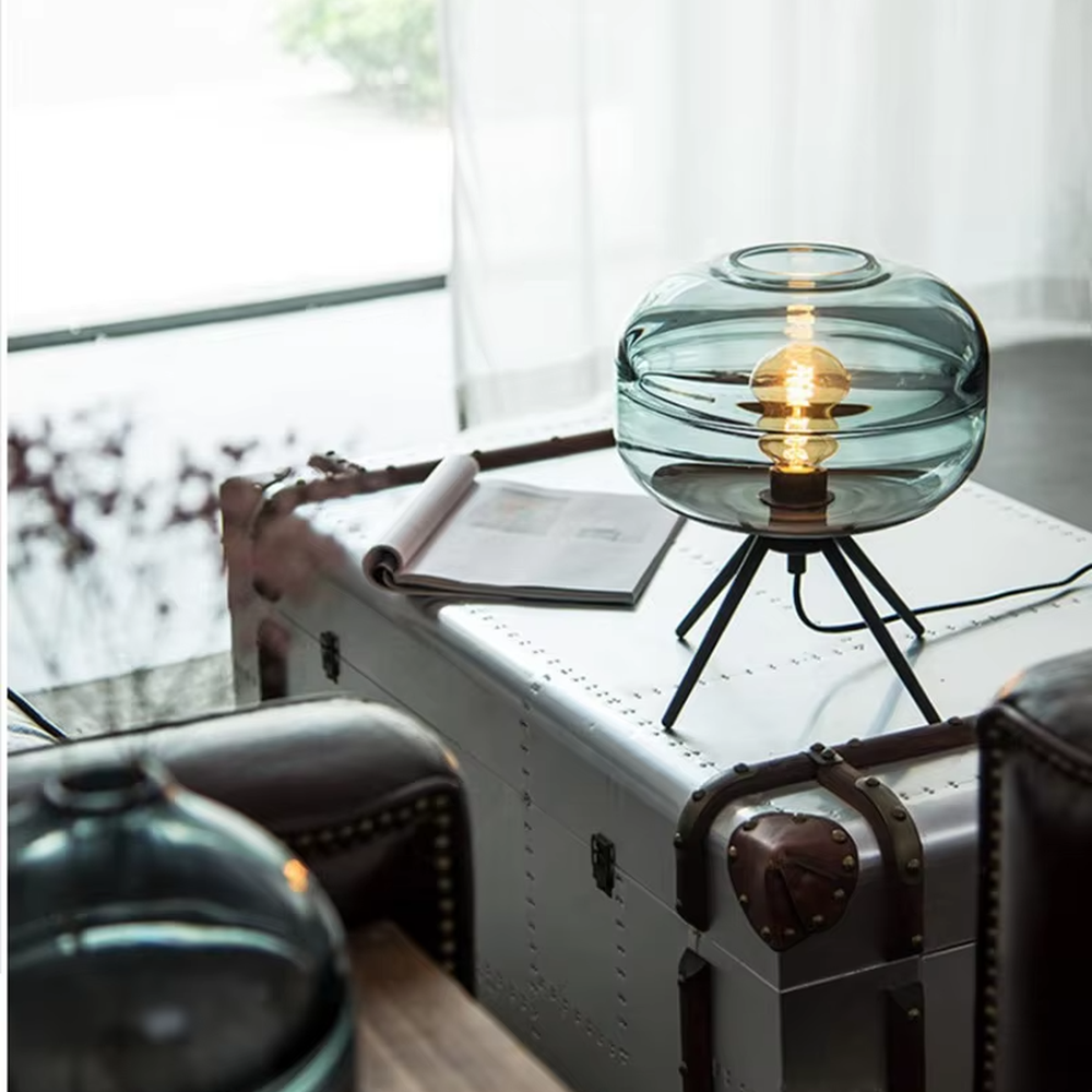 Light luxury dark green glass ball table lamp (dark green double-layer glass ball + black triangular stand), warm light effect, creating a fresh and high-end home atmosphere.