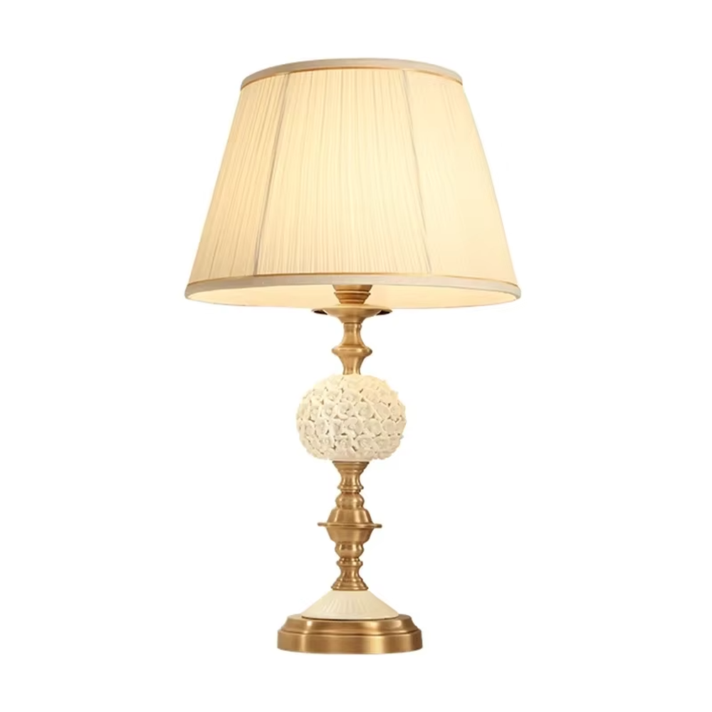 Vintage carved glass table lamp (brass stand + pleated fabric shade), warm light effect, creating an elegant vintage light luxury home atmosphere.