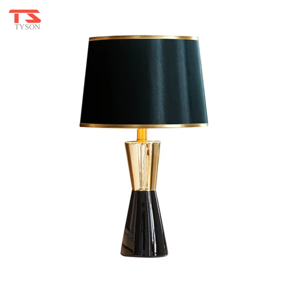 This is a light luxury black-gold table lamp, with a black fabric lampshade edged with gold trim, and a cone-shaped base with a black-gold color block design, featuring both decorative and lighting functions, ideal for high-end indoor scenarios such as bedroom nightstands and living room side tables.