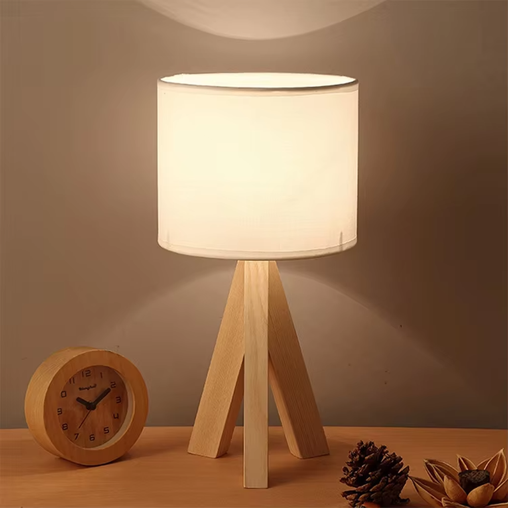 Nordic wooden tripod table lamp (log tripod stand + fabric lampshade), warm light effect, creating a natural and warm home atmosphere.