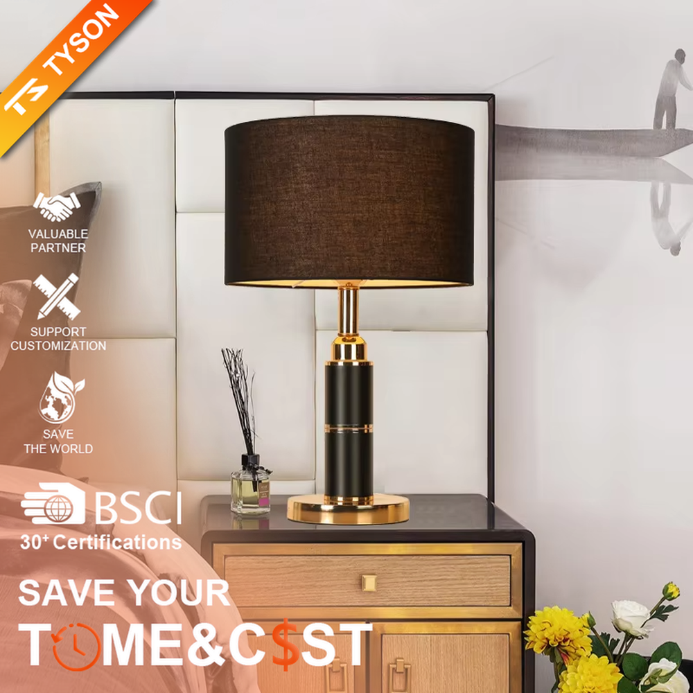 Light luxury black-gold cylindrical base table lamp, black main column + golden metal decorations + beige fabric lampshade, soft warm light creates a high-end home atmosphere.