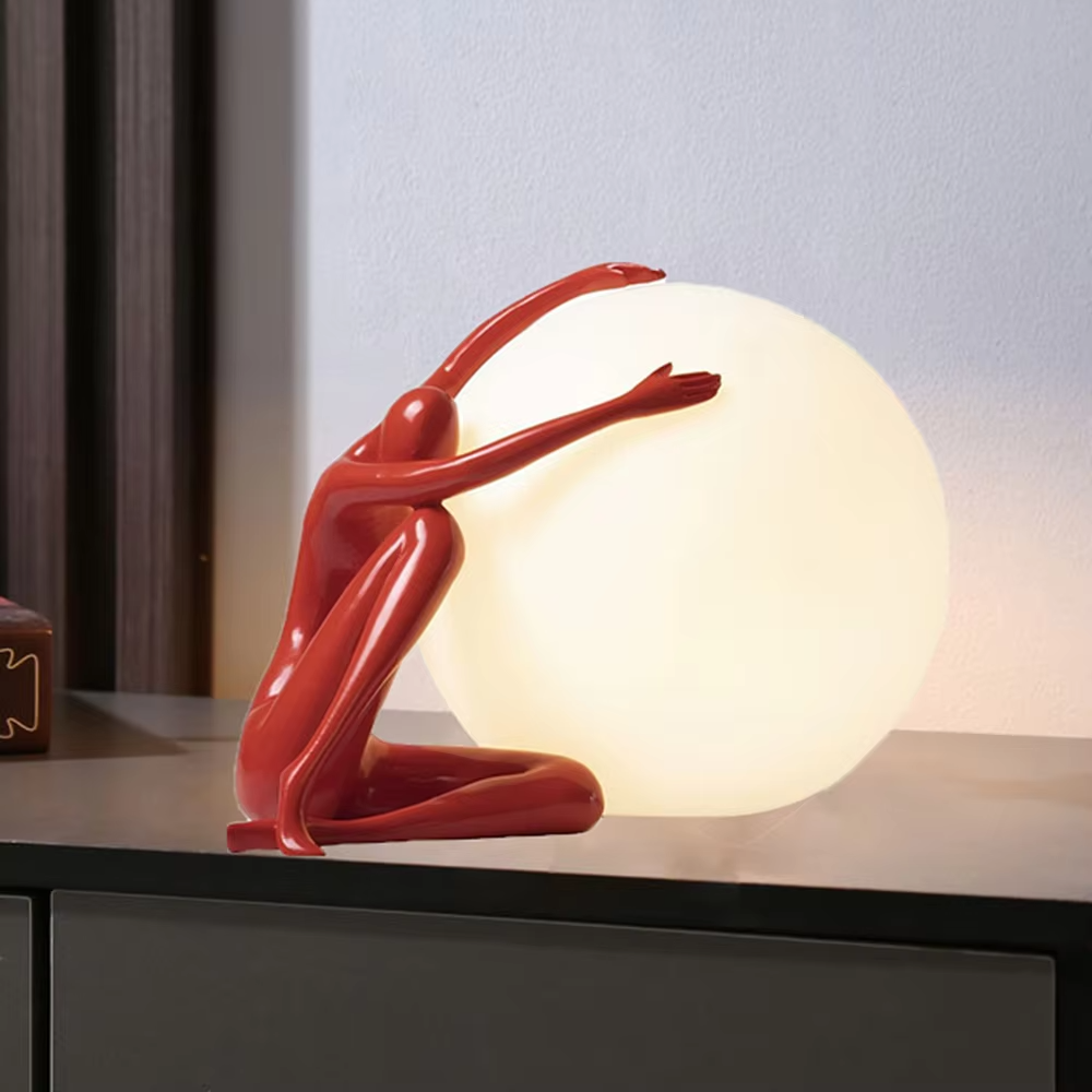 Artistic red sculpture humanoid lifting spherical soft light table lamp, warm light effect, creating a personalized artistic space atmosphere.