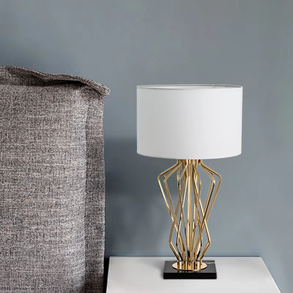 Modern art golden geometric line table lamp (white shade + black base), warm light effect, creating a high-end minimalist creative space atmosphere.