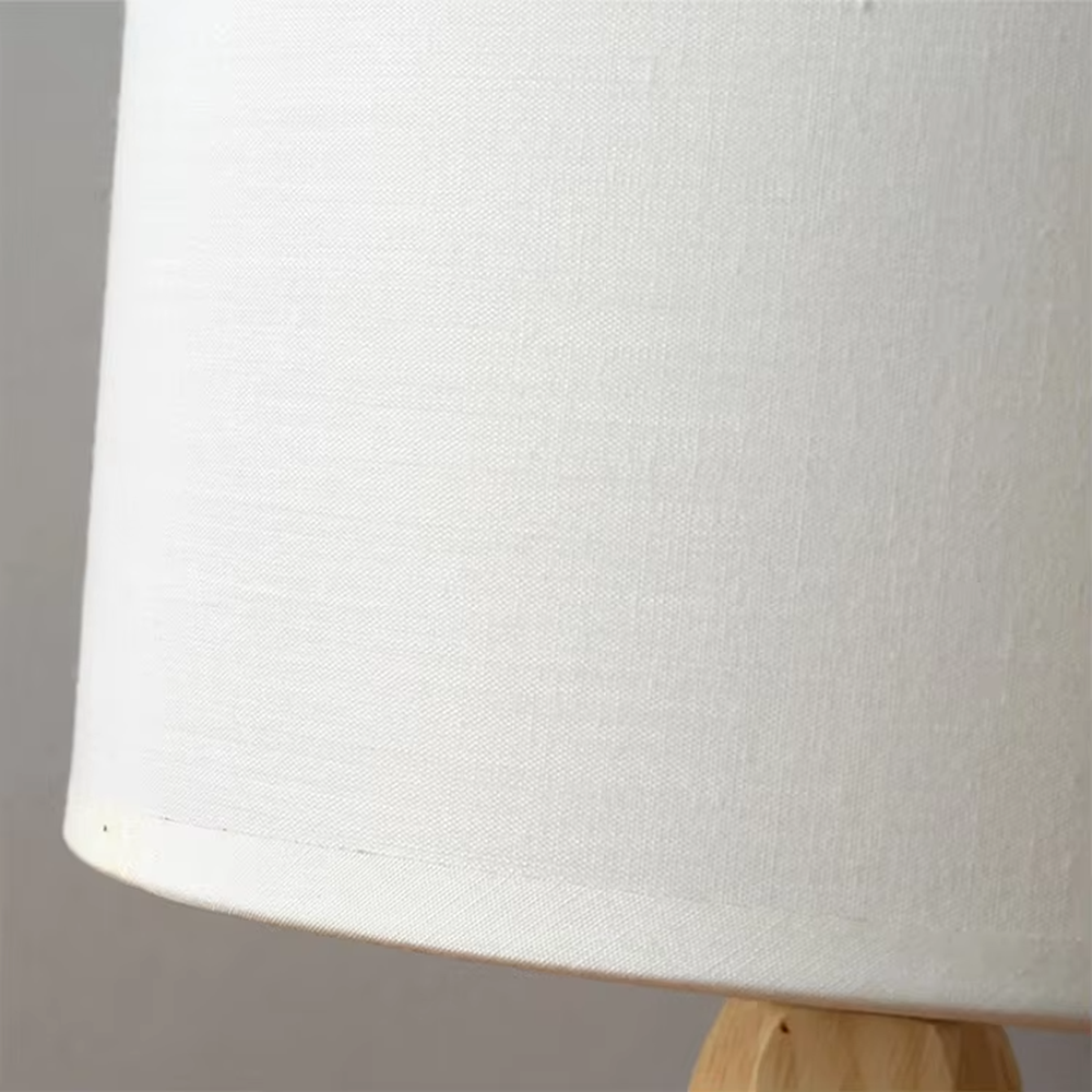 Nordic wooden tripod table lamp (log tripod stand + fabric lampshade), warm light effect, creating a natural and warm home atmosphere.