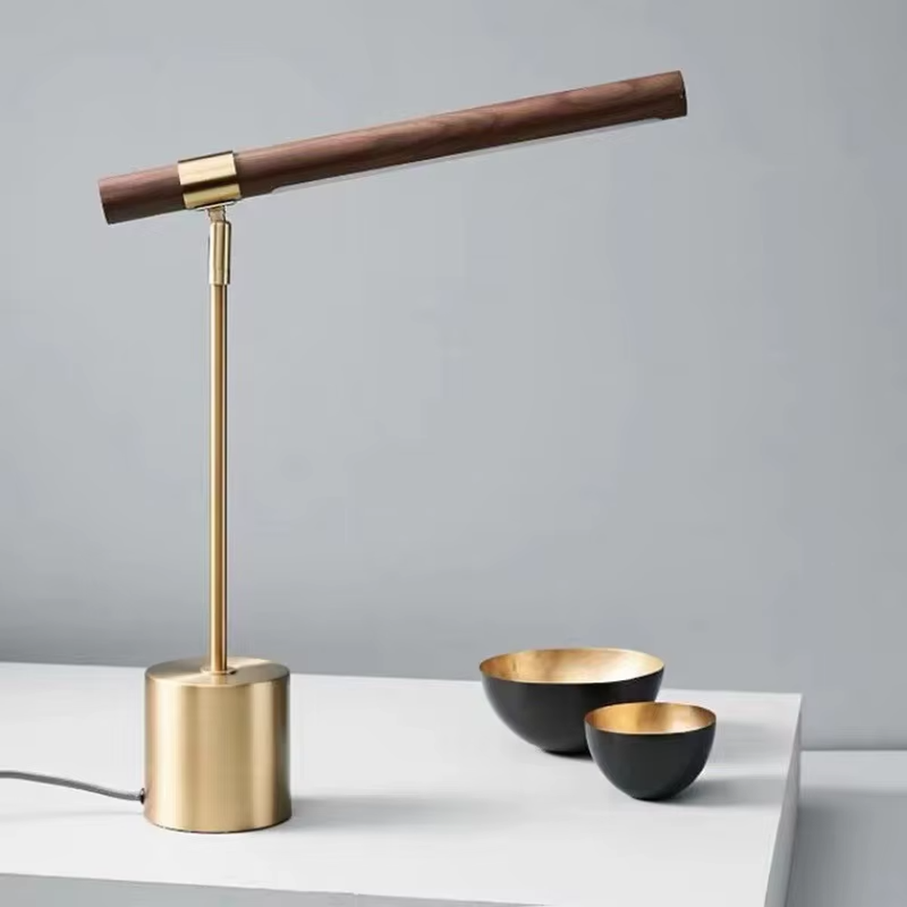 This is a modern minimalist style eye-protecting table lamp, featuring a walnut lamp head paired with a brass metal lamp pole and base. The linear lighting design is soft and non-glaring, serving both practical lighting and decorative purposes, suitable for study rooms, bedroom nightstands, light luxury office areas and other scenarios.