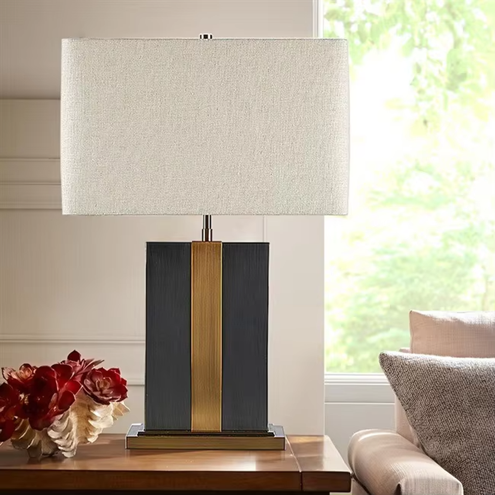 Light luxury color-blocking square base table lamp (black-gold color-blocking base + linen shade), warm light effect, creating a simple and high-end home atmosphere.