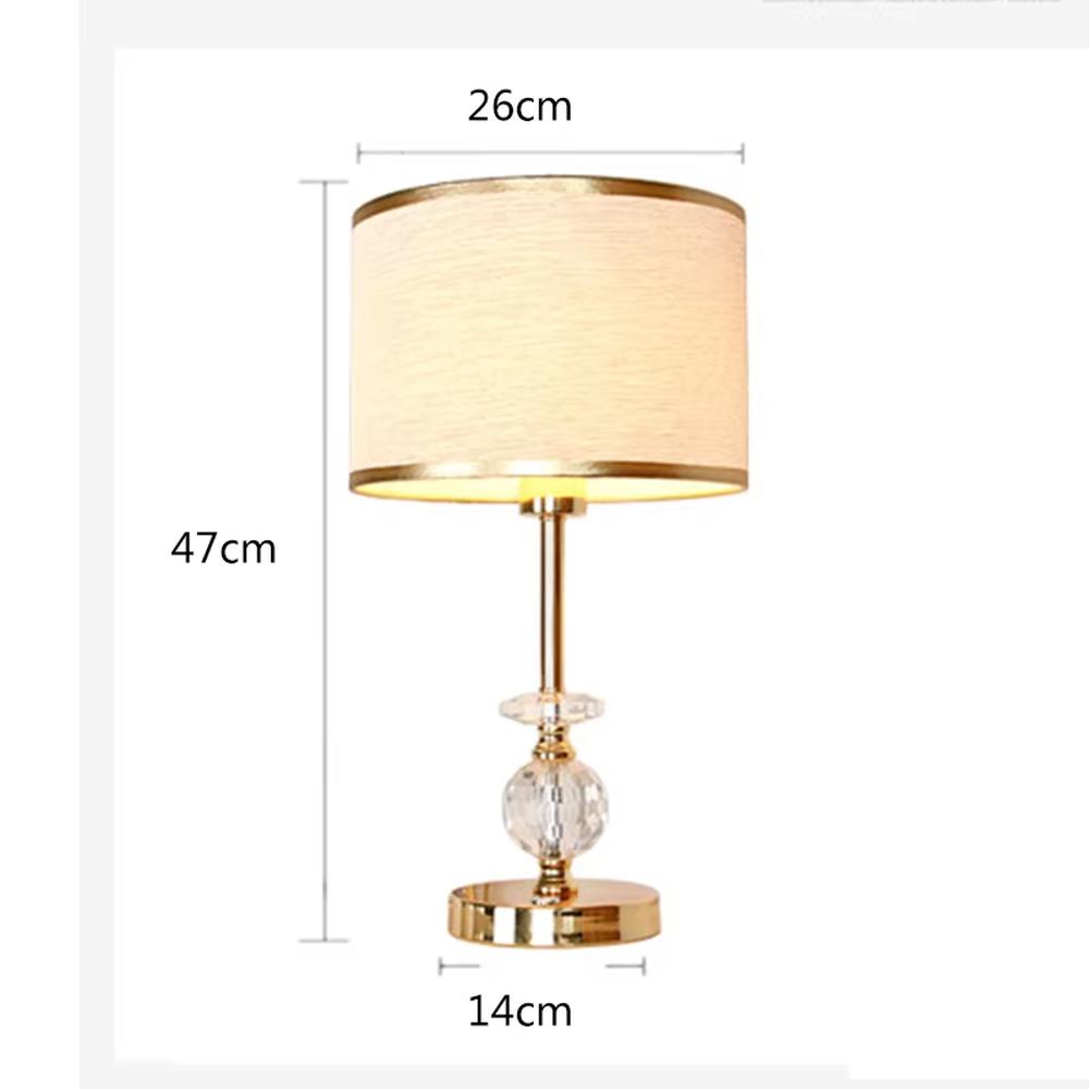 Modern light luxury gold-trimmed white shade golden pole cut crystal decorative table lamp, warm light effect, creating an exquisite and elegant atmosphere.