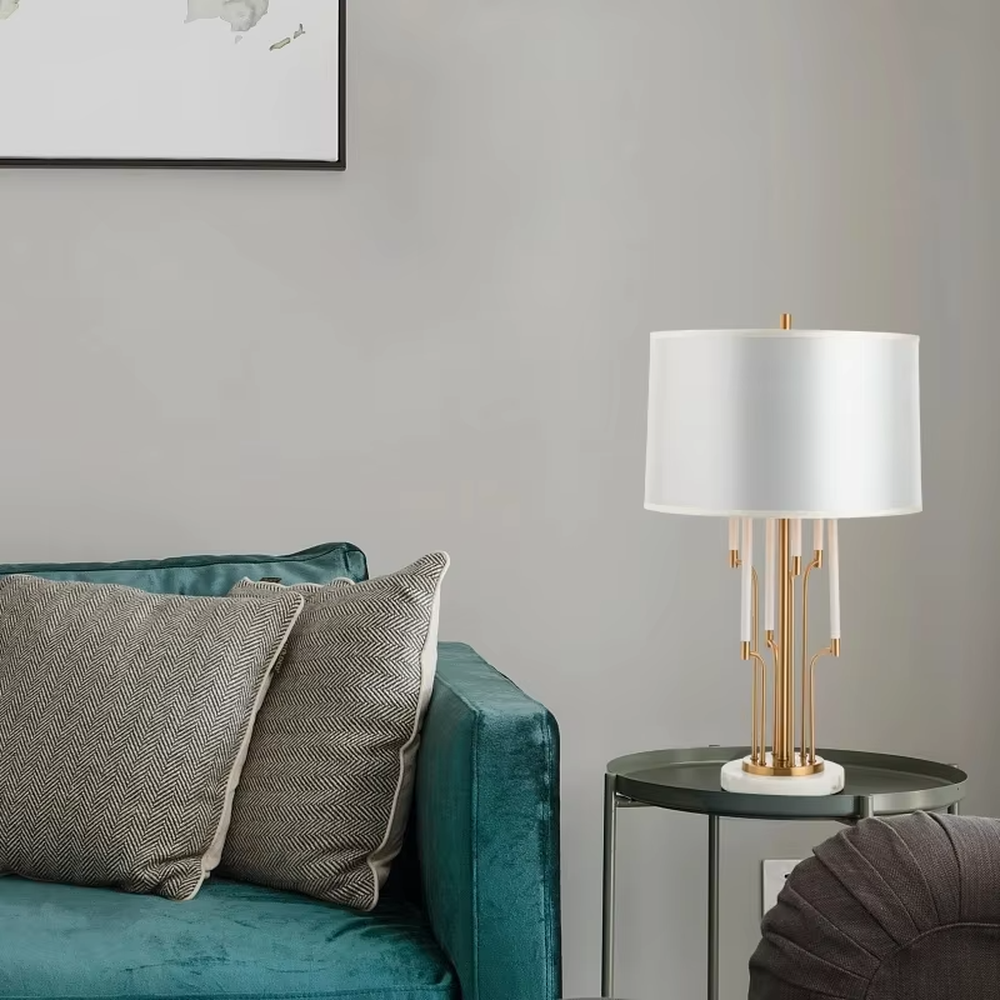 Luxury multi-pole metal table lamp (gold pole + white shade + marble base), warm light effect, creating an elegant and high-end light luxury space atmosphere.