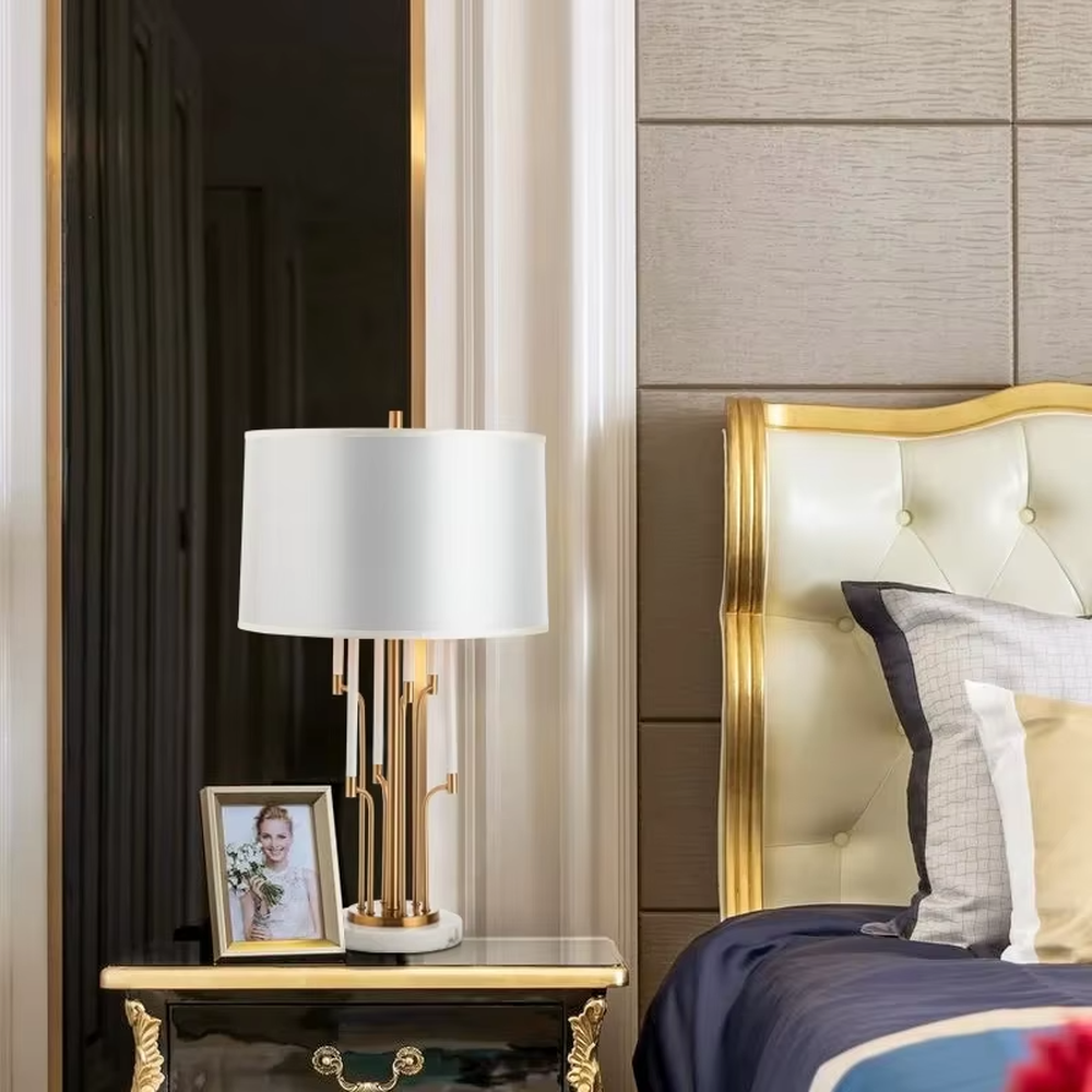 Luxury multi-pole metal table lamp (gold pole + white shade + marble base), warm light effect, creating an elegant and high-end light luxury space atmosphere.