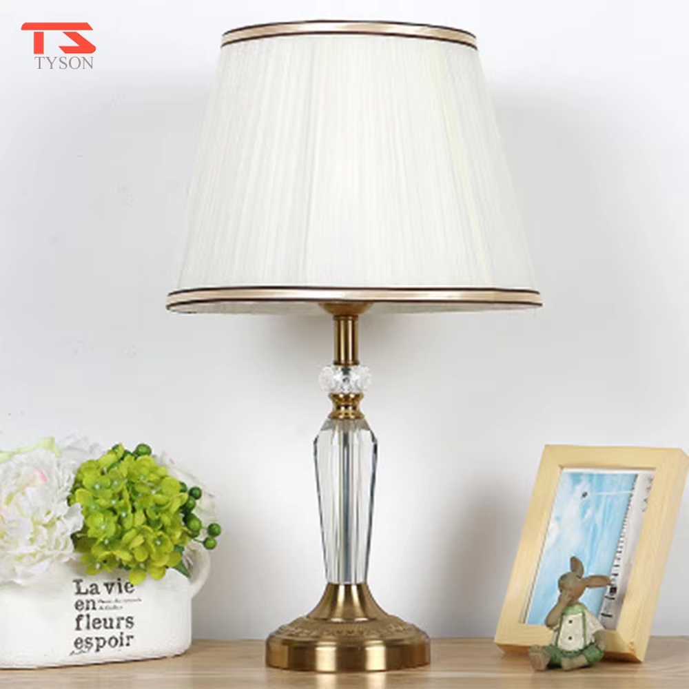 Light luxury crystal fabric table lamp (pleated fabric lampshade + crystal lamp post + antique bronze metal base), warm light effect, creating an elegant and luxurious home atmosphere.