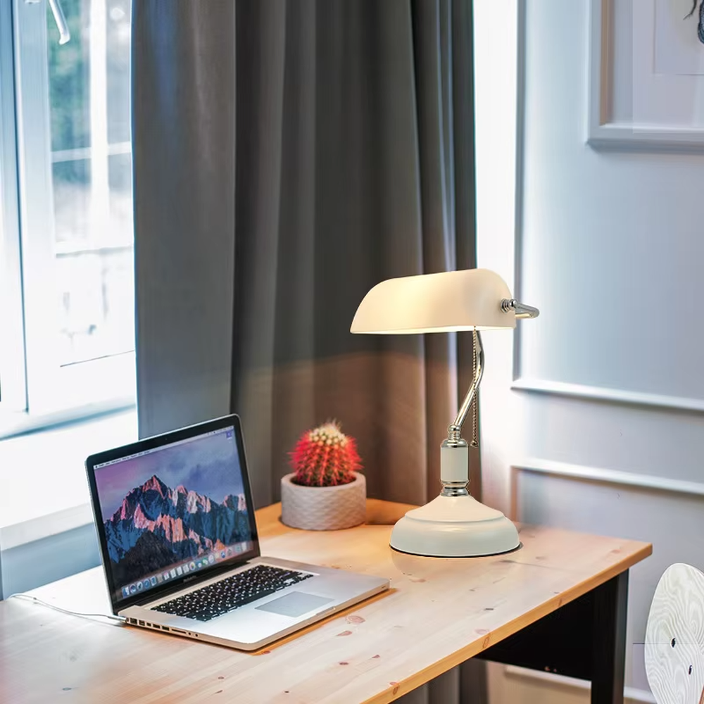 Vintage industrial-style green shade brass adjustable table lamp, semi-circular green shade + brass metal stand + pull chain switch, soft warm light creates vintage atmosphere.