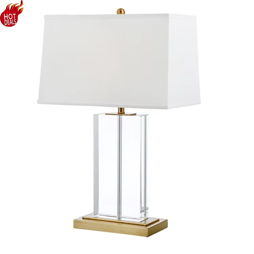 Modern light luxury marble and metal spliced table lamp, with a gray marble lamp body paired with gold metal decorative strips, a light gray fabric rectangular lampshade (with a gold ball decoration on top), emitting soft and elegant light, combining decorativeness and practicality, suitable for lighting and decoration in spaces such as bedroom nightstands, living room side tables, and hotel guest rooms.