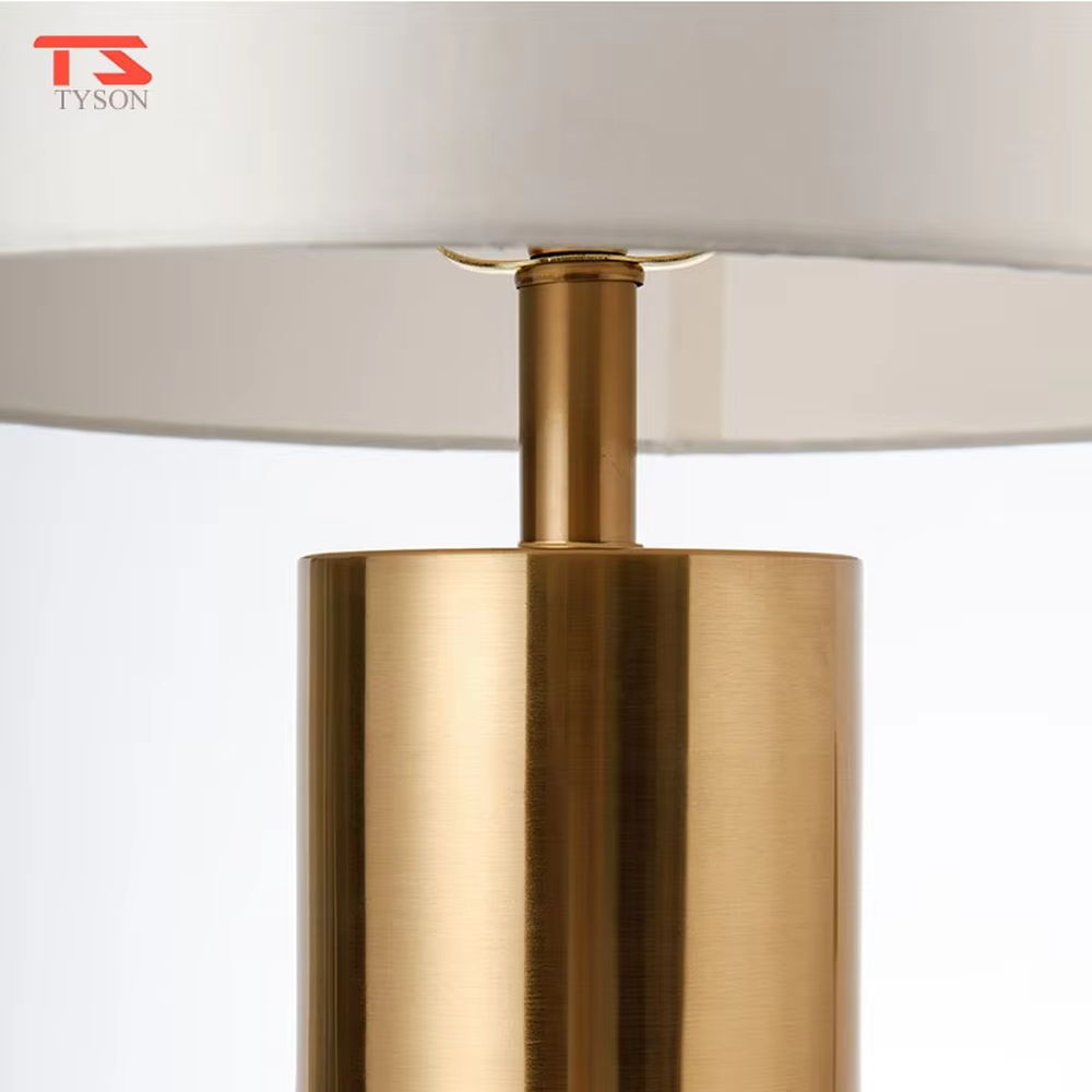 This is a light luxury marble-metal splicing table lamp, with a white fabric lampshade paired with a base made of gold metal and gray marble, accented with an orange decorative ball on top, featuring both decorative and lighting functions, ideal for high-end indoor scenarios such as bedroom nightstands and living room side tables.