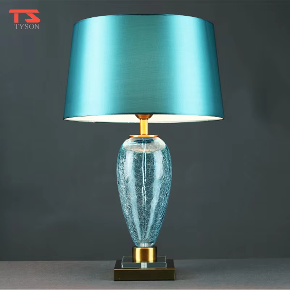 Light luxury lake blue glass bottle-shaped table lamp (satin fabric shade + gold trim), warm light effect, creating a fresh and elegant space atmosphere.