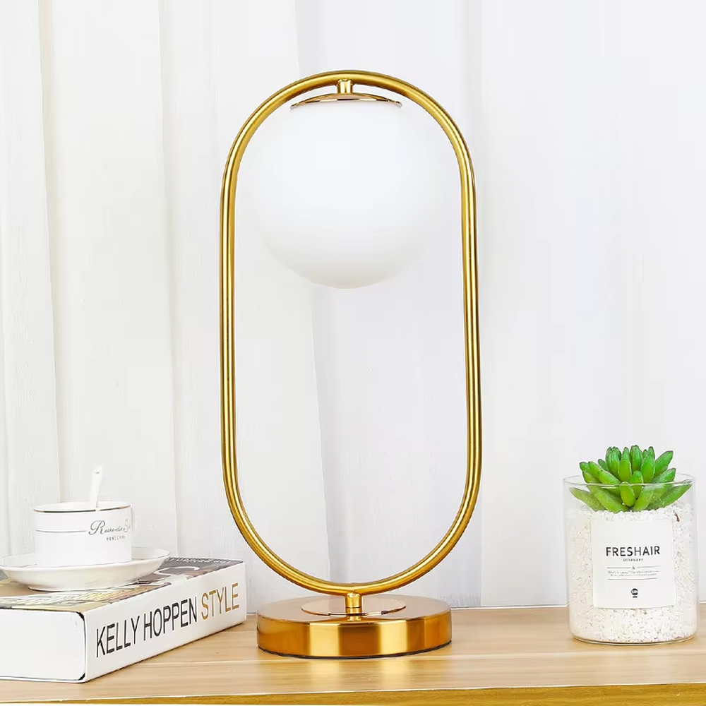 This is a modern minimalist metal frame table lamp, with a black oval metal stand paired with a white spherical frosted lampshade, featuring a simple and elegant design, both decorative and lighting functions, ideal for modern indoor scenarios such as desks and nightstands.