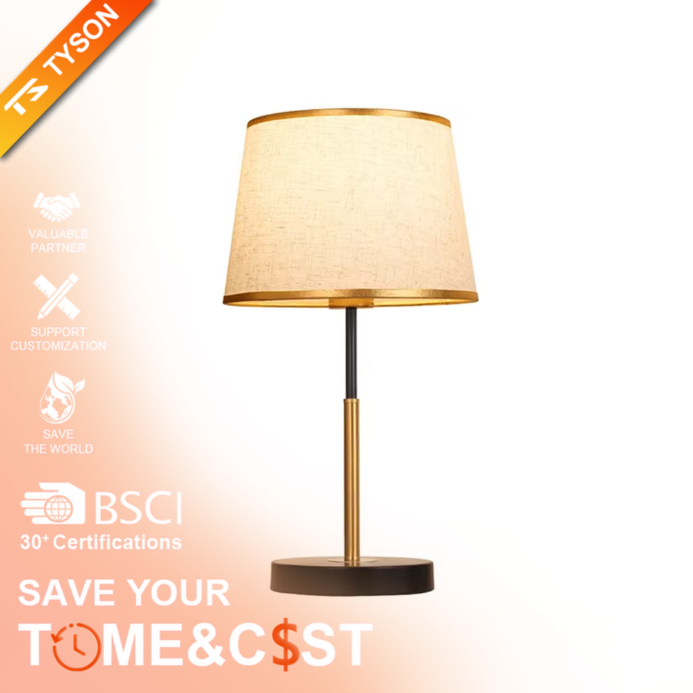 Modern light luxury fabric table lamp, with an off-white fabric lampshade (with gold trim on the top and bottom edges) paired with a black-gold spliced lamp pole and a black disc base, emitting soft and warm light, combining decorativeness and practicality, suitable for lighting and decoration in spaces such as bedroom nightstands, living room side tables, and studies.