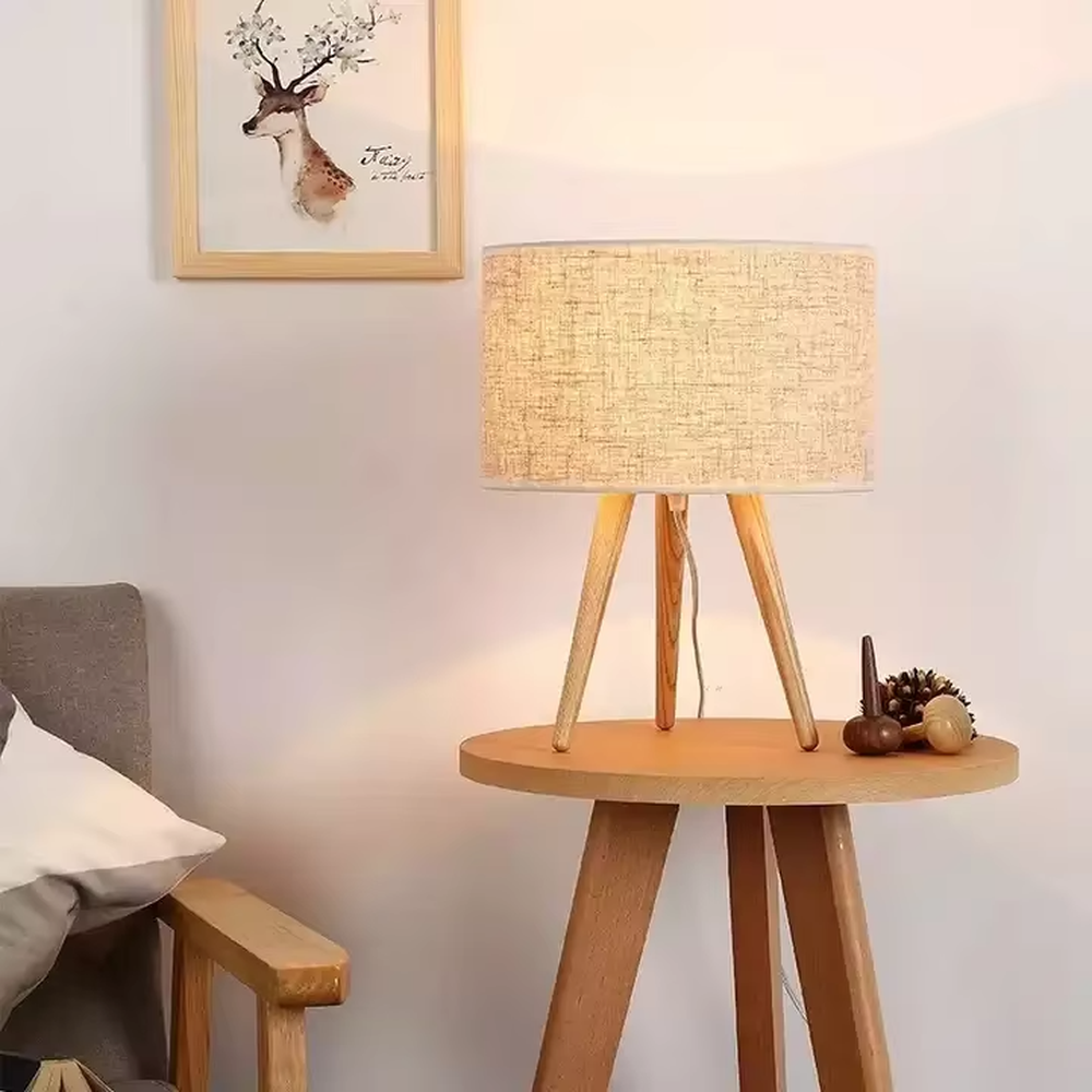 Wooden-style triangular stand table lamp (wooden tripod + linen lampshade), warm light effect, creating a natural and healing home atmosphere.