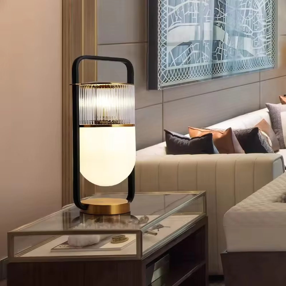 This modern light luxury lantern-shaped table lamp features a black-gold metal frame (with a handle design), paired with a double-layer lampshade of vertical-grain transparent glass and milk-white frosted glass, with an exquisite gold base. It serves both lighting and decorative purposes, ideal for light luxury spaces such as bedroom bedside tables, living room side tables, and hotel guest rooms.