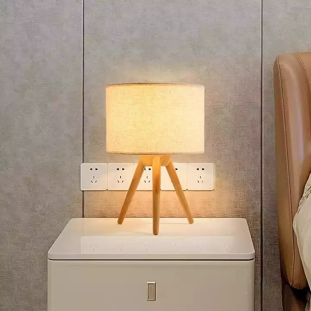 Wooden-style triangular stand table lamp (wooden tripod + linen lampshade), warm light effect, creating a natural and healing home atmosphere.