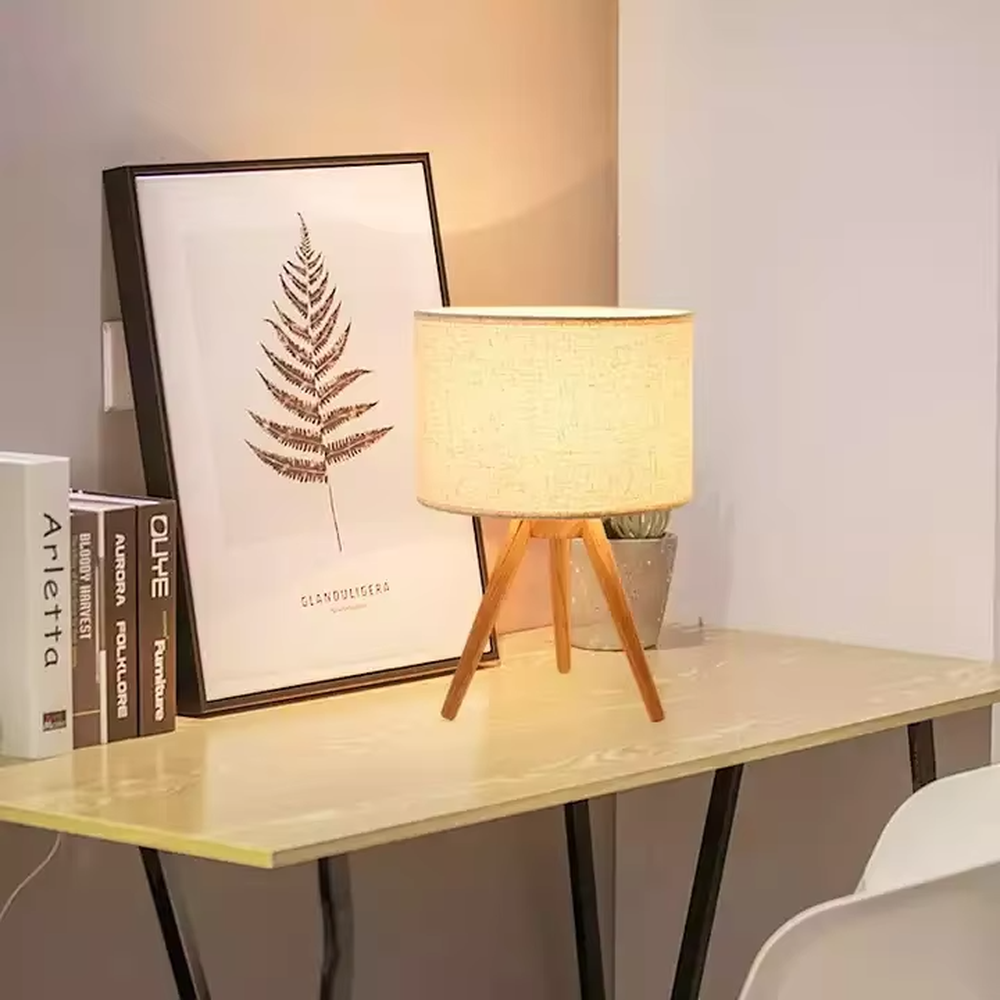 Wooden-style triangular stand table lamp (wooden tripod + linen lampshade), warm light effect, creating a natural and healing home atmosphere.