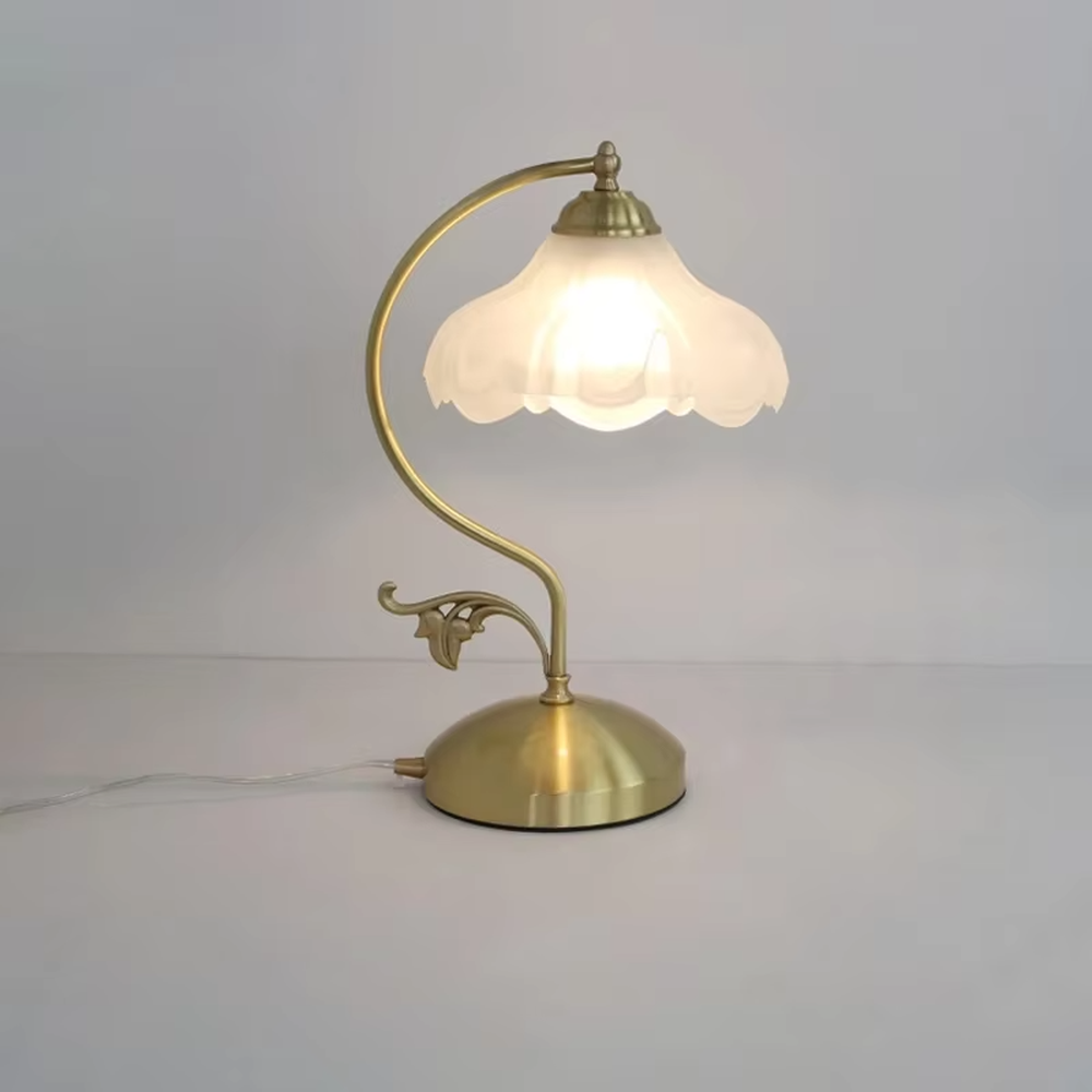 Vintage pastoral style flower-shaped table lamp, with a black wrought iron curved lamp pole with leaf decoration, paired with a white frosted glass petal lampshade. It emits soft and warm light, combining decorativeness and practicality, suitable for lighting and decoration in spaces such as bedroom nightstands, study desks, and B&B guest rooms.