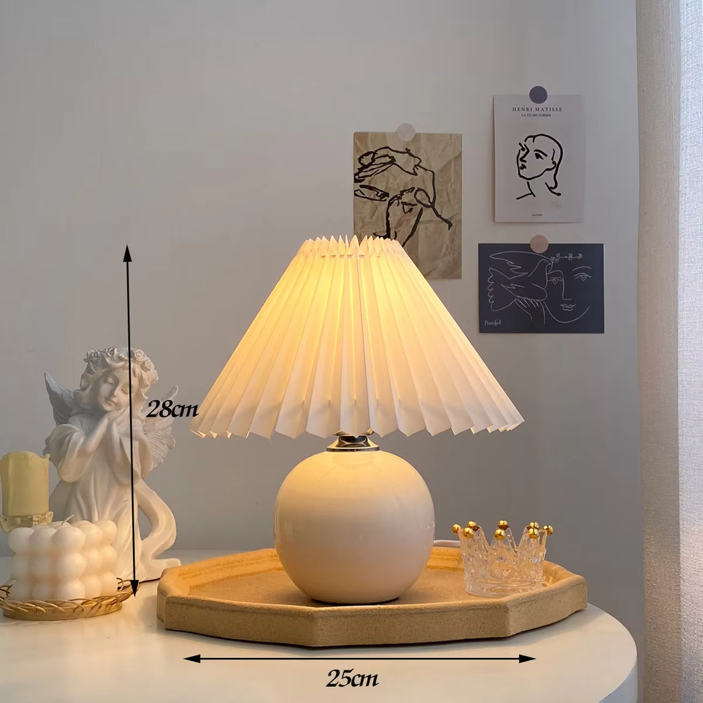 Fresh pleated umbrella shade table lamp (cream yellow glaze ball body + white pleated shade), warm light effect, creating a soft and healing home atmosphere.