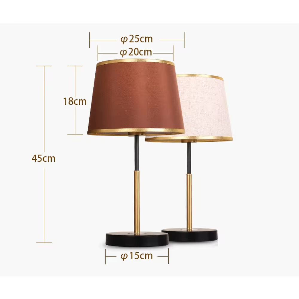 Modern light luxury fabric table lamp, with an off-white fabric lampshade (with gold trim on the top and bottom edges) paired with a black-gold spliced lamp pole and a black disc base, emitting soft and warm light, combining decorativeness and practicality, suitable for lighting and decoration in spaces such as bedroom nightstands, living room side tables, and studies.