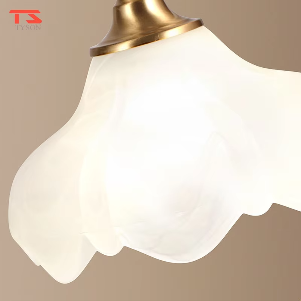 Vintage light luxury brass curved-arm petal lampshade table lamp, brass metal material + white petal translucent shade + warm light effect, creating an elegant and cozy home atmosphere.