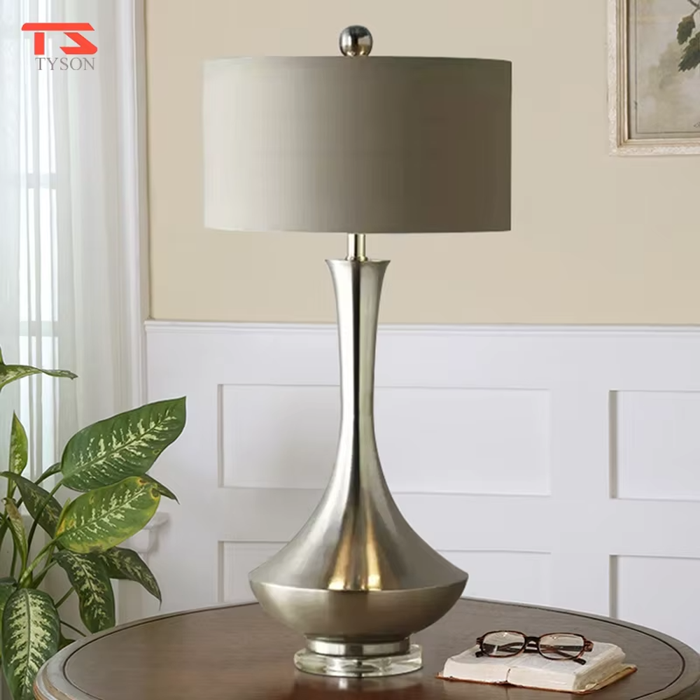 Modern minimalist silver bottle-shaped metal pole light beige fabric shade table lamp, warm light effect, creating an elegant light luxury home atmosphere.
