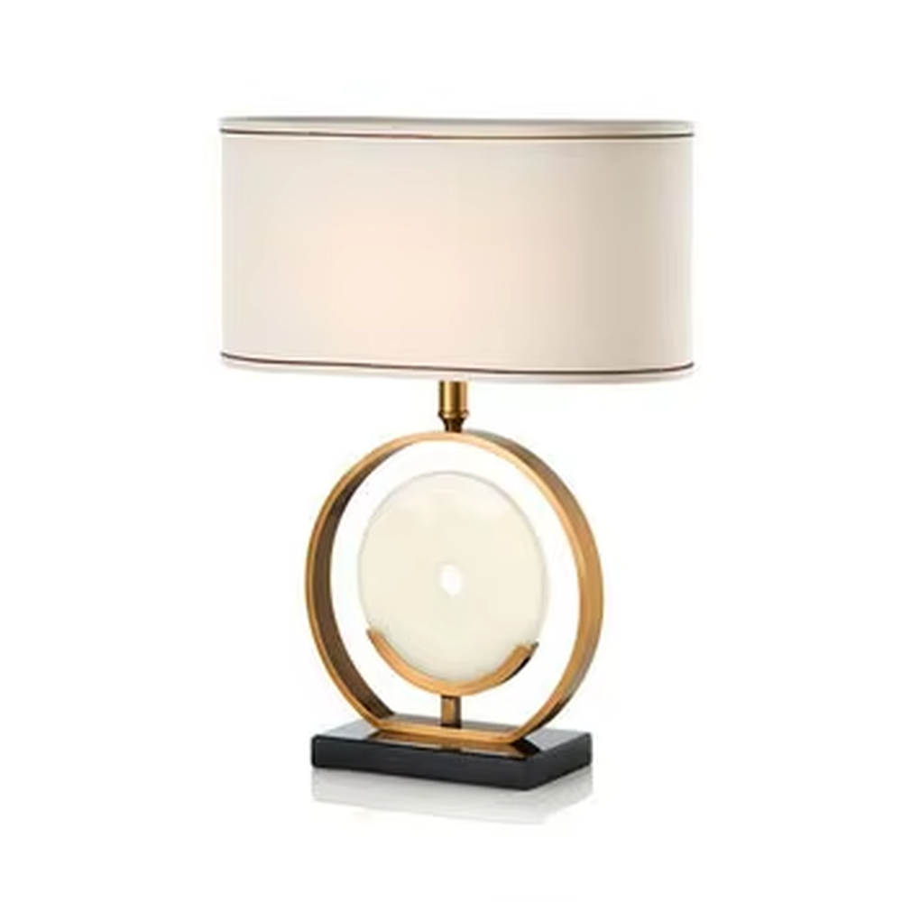 Modern light luxury gold ring white spherical base beige trimmed fabric shade table lamp, warm light effect, creating an elegant home atmosphere.