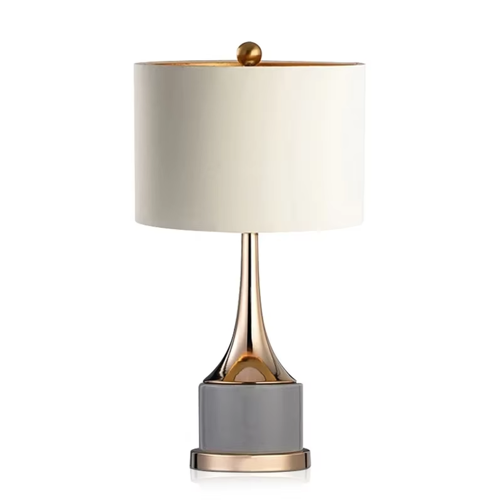 Light luxury gray-gold fabric lampshade metal base table lamp (gray fabric shade + gold pole + gray stone-pattern base), warm light effect, creating an exquisite and elegant atmosphere.