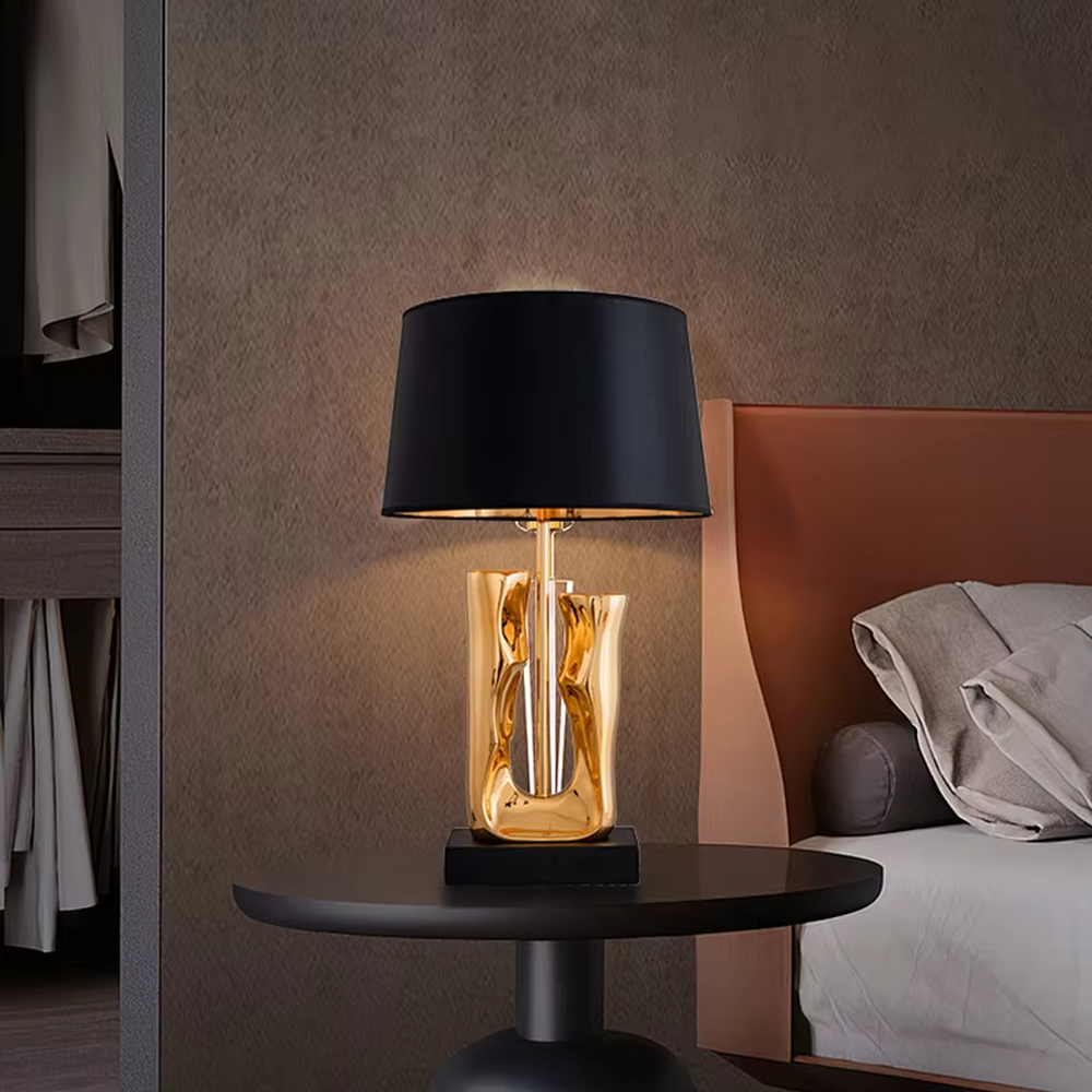 Modern art luxury black-gold sculpture base table lamp, golden streamlined sculpture base + black shade with gold lining + warm light effect, creating a high-end artistic luxury atmosphere.
