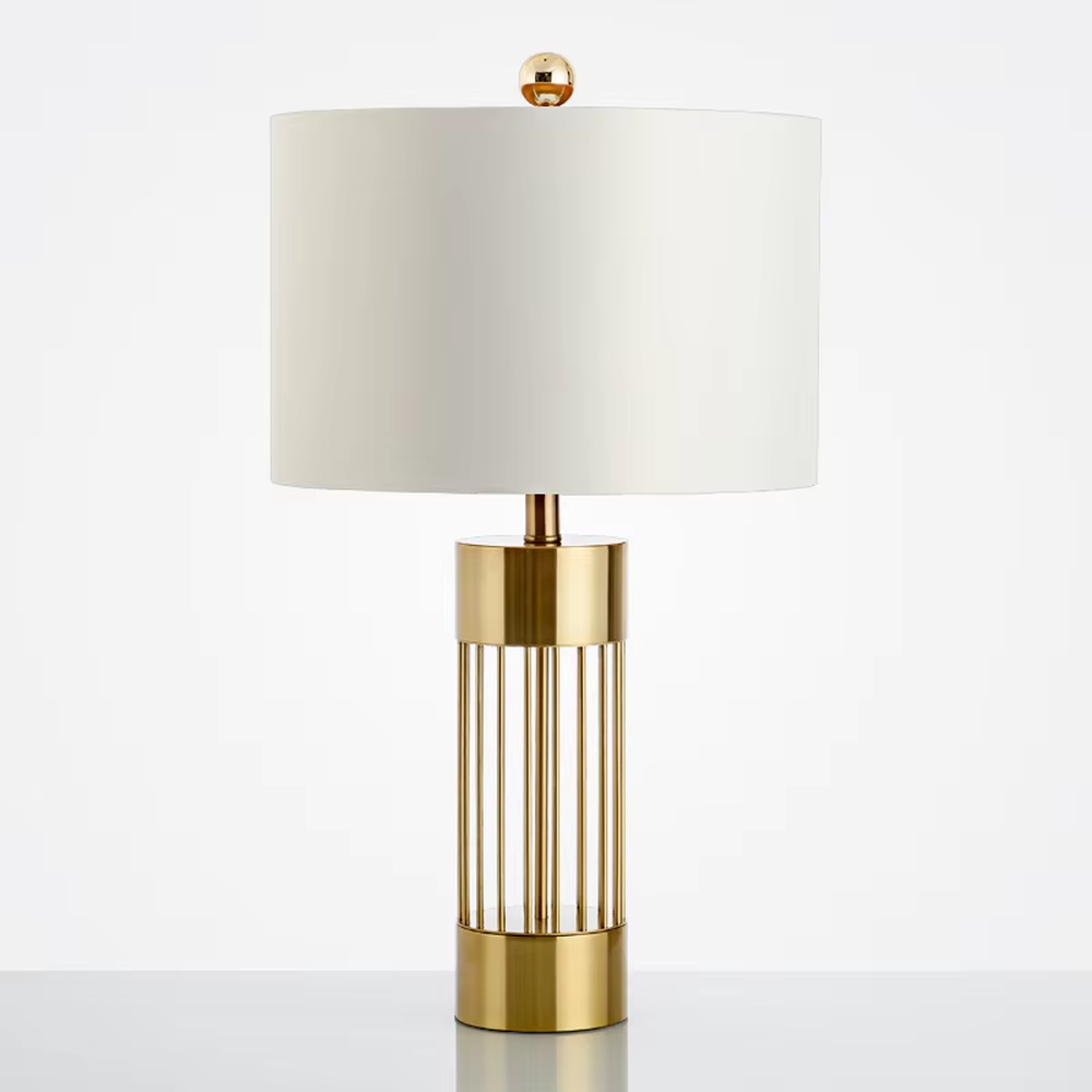 Light luxury gold grid cylinder table lamp (gold grid base + fabric lampshade), warm light effect, creating a high-end minimalist home atmosphere.