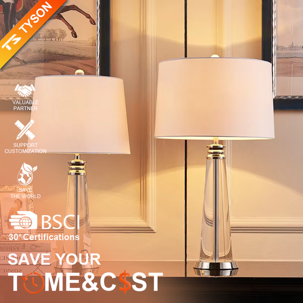 Light luxury crystal column table lamp, transparent cut crystal column base with silver metal details and white fabric lampshade, available in a set of two sizes, soft and even light, designed to enhance the delicate and elegant atmosphere of spaces, suitable for bedroom nightstands, living room side tables, modern light luxury homes and hotel guest rooms, etc.