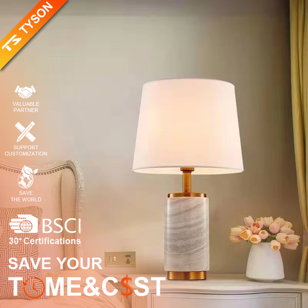 Light luxury white marble cylindrical table lamp, white marble base + golden metal decorations + beige fabric lampshade, soft warm light, creating an elegant light luxury home atmosphere.