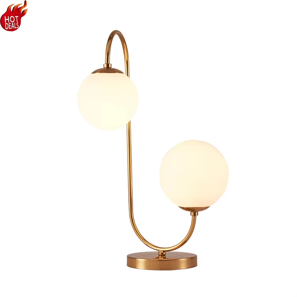 Light luxury double-ball curved table lamp (gold metal curved bracket + double milk-white glass ball lampshades + round metal base), warm light effect, creating a modern and elegant home atmosphere.