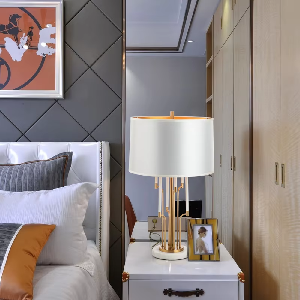 Light luxury golden multi-rod shaped table lamp, white fabric gold-edged lampshade + golden multi-rod stand + white-gold base, soft warm light, creating a high-end light luxury bedroom atmosphere.