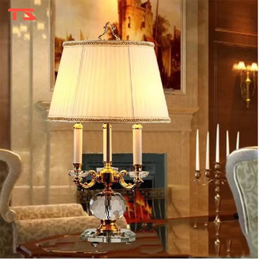 This European court-style table lamp features a carved lamp frame made of glossy gold metal, paired with a crystal ball base and a pleated fabric lampshade (trimmed with gold edging). It presents a luxurious and retro texture, with soft and warm light, serving both lighting and decorative purposes, suitable for European-style bedrooms, villa guest rooms and other spaces.