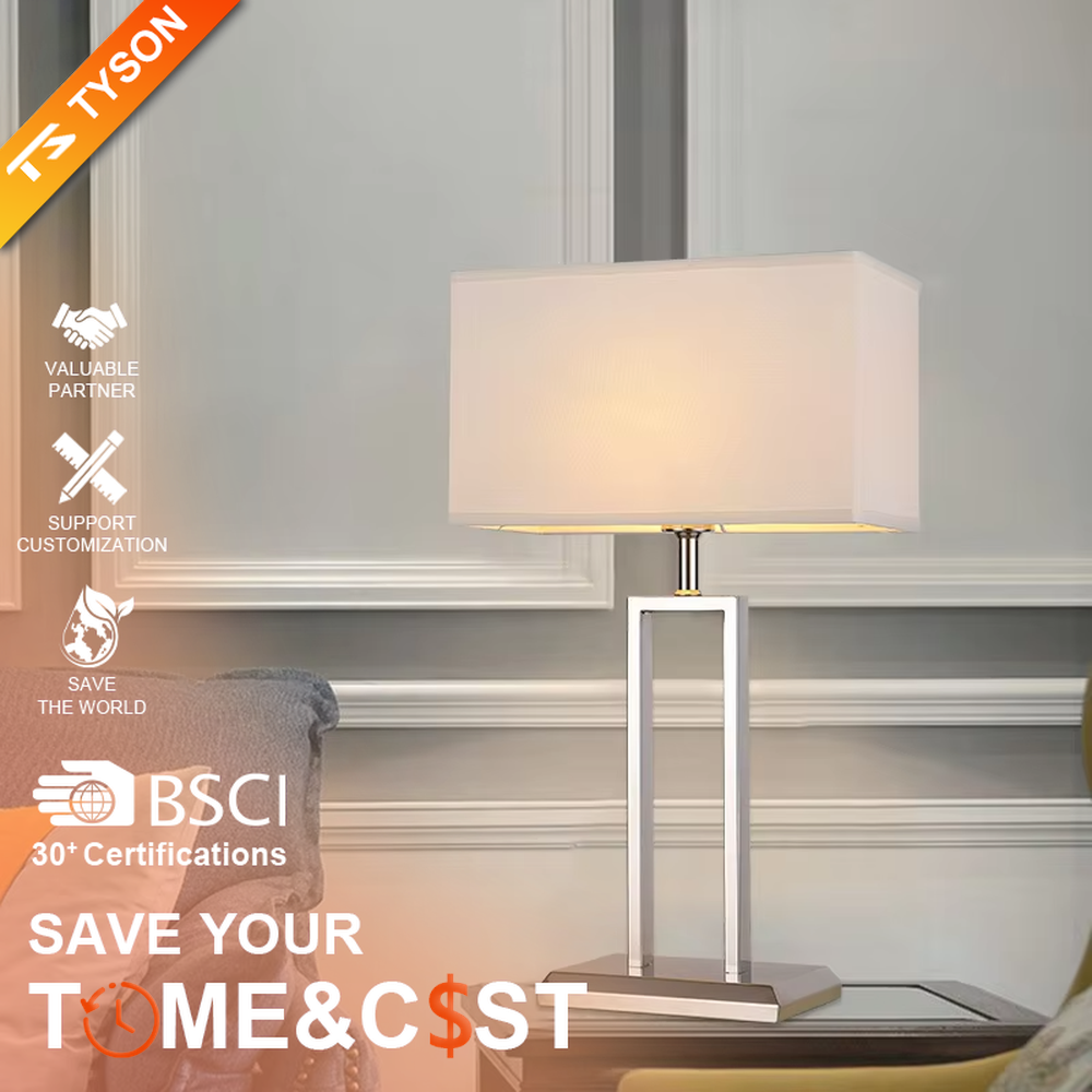 Modern minimalist table lamp with a chrome-plated metal frame and a rectangular off-white fabric lampshade, emitting soft and warm light. It is both decorative and practical, suitable for lighting and decoration in living rooms, bedrooms, studies and other spaces.