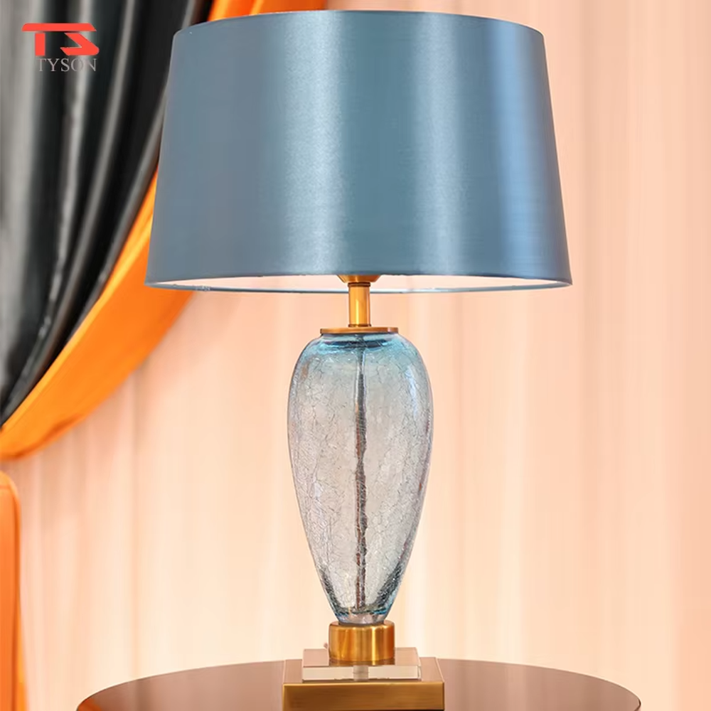 Light luxury lake blue glass bottle-shaped table lamp (satin fabric shade + gold trim), warm light effect, creating a fresh and elegant space atmosphere.