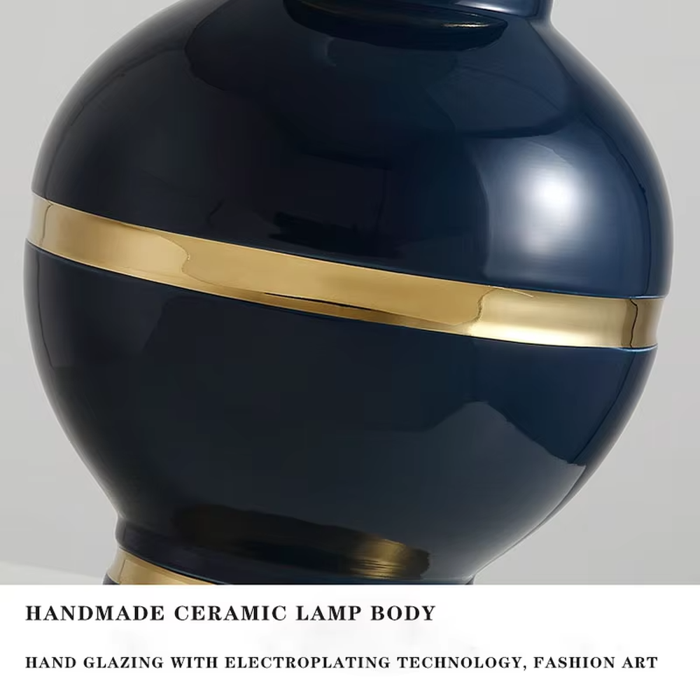 This is a light luxury European-style ceramic table lamp, with a dark blue ceramic base paired with gold metal decorations, and a light blue vertical-striped fabric lampshade edged with a gold ribbon, which has both lighting and decorative functions, suitable for bedroom nightstands, living room side tables, hotel guest rooms and other spaces.