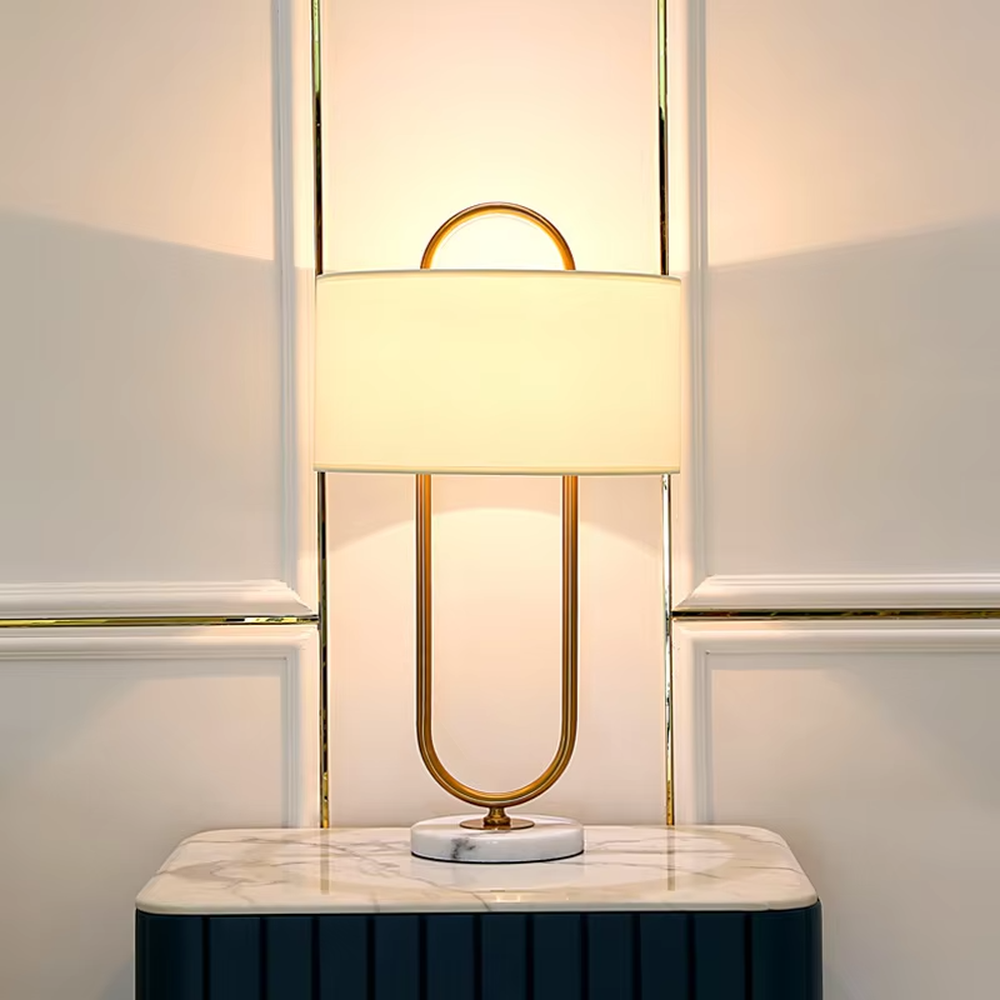 Light luxury U-shaped gold frame table lamp (gold U-shaped stand + fabric shade + marble base), warm light effect, creating an elegant and high-end home atmosphere.