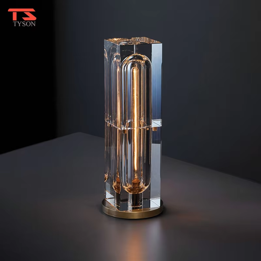 Modern light luxury cut crystal column table lamp, with a transparent multi-faceted cut crystal lamp body paired with a gold metal base, emitting soft and transparent light, combining decorativeness and practicality, suitable for lighting and decoration in spaces such as bedroom nightstands, living room side tables, and hotel guest rooms.