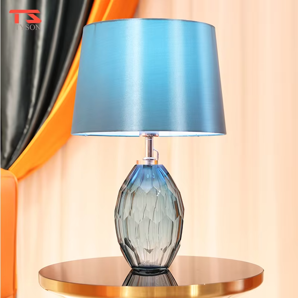 This light luxury modern table lamp features a blue-gray cut-textured glass lamp body, paired with a sky-blue fabric conical lampshade, with exquisite metal connectors. It serves both lighting and decorative purposes, ideal for light luxury spaces such as bedroom bedside tables, living room side tables, and hotel guest rooms.